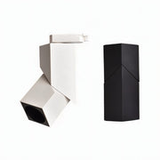 White and black adjustable track light fixtures shown on white background.