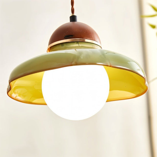 "Close-up of a handcrafted ceramic pendant light shade with a curved design, showcasing its texture and warm, diffused light."
