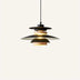 Modern pendant light with black metal and natural wood tiers emitting warm light against a neutral background.