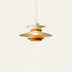 Tiered pendant light with brass and copper-toned metal shades suspended against a neutral background.