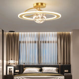 "A gold ceiling light with two rings and a central glass sphere, installed in a bedroom with a patterned headboard and curtains."