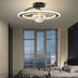 "A black ceiling light with two rings and a central glass sphere with fairy lights, installed in a bedroom with a gray bed and blinds on the window."