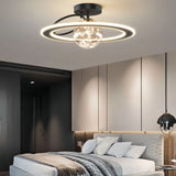 "A black ceiling light with two rings and a central glass sphere with fairy lights, installed in a bedroom with a gray bed and a dark gray wall panel."