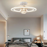 "A white ceiling light with two rings and a central glass sphere with fairy lights, installed in a bedroom with a gray bed and artwork."