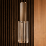 Detailed view of Nayra Copper Glass Pendant Light highlighting its ribbed glass and copper top, ideal for sculptural lighting in living spaces.