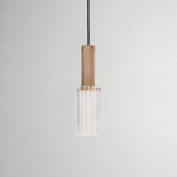 Studio shot of Nayra Copper Glass Pendant Light with clear ribbed glass and copper finish, suitable for minimalist modern lighting setups.