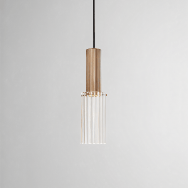 Studio shot of Nayra Copper Glass Pendant Light with clear ribbed glass and copper finish, suitable for minimalist modern lighting setups.