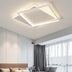 Modern geometric ceiling light with brushed silver frame and warm white LED glow in contemporary bedroom setting.
