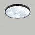 Round ceiling light with black metal trim and frosted white glass diffuser mounted on gray wall.