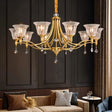 "Elegant chandelier with iron frame, curved arms, glass shades, and crystal accents in a grand living room."