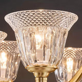 "Close-up of an intricate glass shade on an elegant chandelier, showcasing its texture and design."