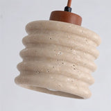 "Close-up of a travertine pendant light with a ribbed design showing texture."