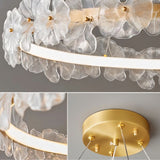 "Close-up details of a chandelier with sculpted glass petals and an iron frame."