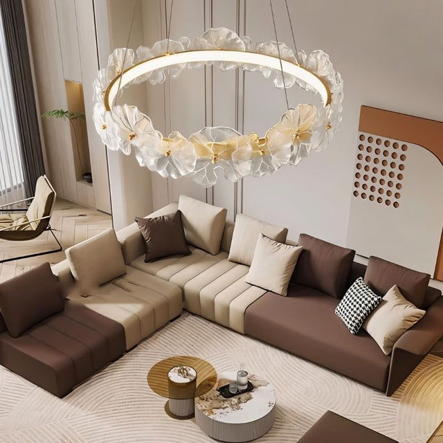 "A circular chandelier with sculpted glass petals and an iron frame in a living room."