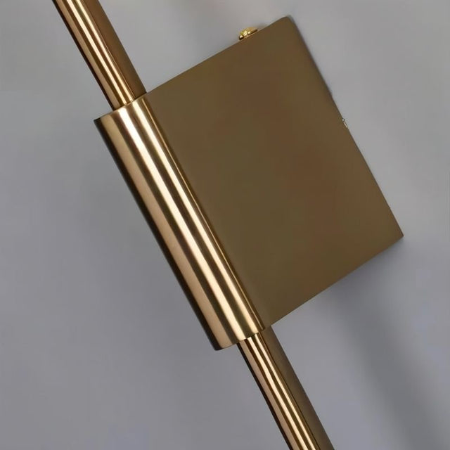 "Close-up detail of a modern wall lamp with a sleek iron frame and a square mounting plate."