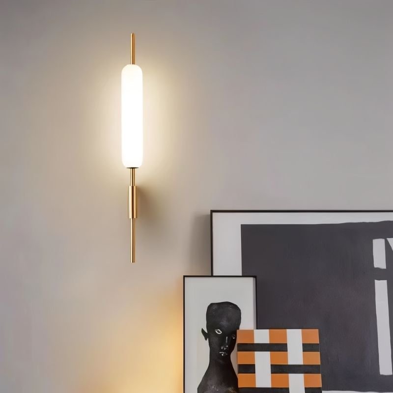 "Modern wall lamp with a cylindrical glass diffuser and iron frame providing accent lighting in a contemporary living room."