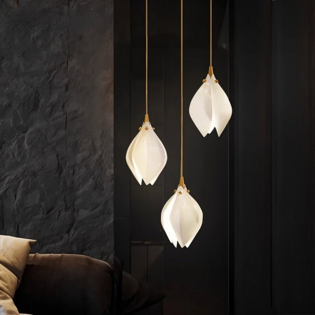 Nica Chandelier – Elegant Lighting for Modern Interiors showcasing three warm-glow ceramic pendants in a dark modern interior, ideal for lounges.