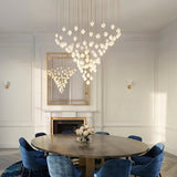 Nica Chandelier – Elegant Lighting for Modern Interiors in a luxurious dining room with cascading porcelain pendants forming a sculptural centerpiece.