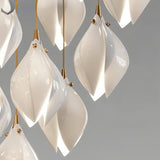 Nica Chandelier – Elegant Lighting for Modern Interiors close-up of glossy ceramic petals with gold fittings, showcasing craftsmanship and elegance.