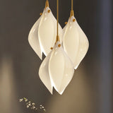 Nica Chandelier – Elegant Lighting for Modern Interiors featuring a close-up of clustered ceramic petals with gold accents, ideal for upscale interiors.