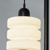 "Close-up of the layered frosted glass diffuser with a black iron top on a modern pendant light."