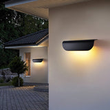 "Modern outdoor wall lamp with a minimalist half-cylinder design made of durable aluminum, emitting a soft, diffused glow, enhancing outdoor aesthetics."