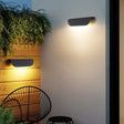 "Sleek aluminum outdoor lamp with a contemporary half-cylinder design, providing a soft glow for patios and modern outdoor spaces."