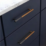 "Two minimalist aluminum pull bars on dark blue kitchen cabinets with a white marble countertop."