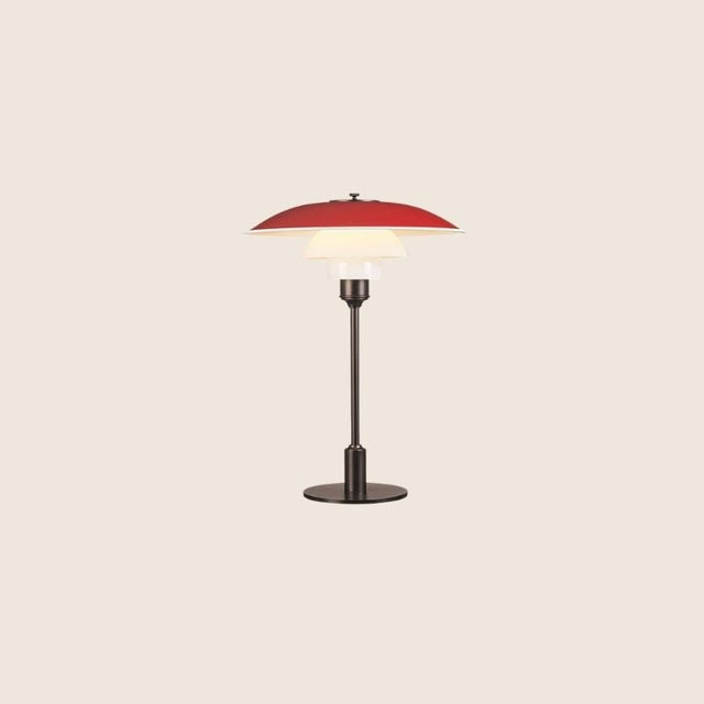 "Nisra Table Lamp with a red top shade and frosted glass diffuser, made from aluminum, iron, and glass, offering soft, ambient lighting in a modern design."