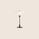 "Nisra Table Lamp with a white top shade and frosted glass diffuser, crafted from aluminum, iron, and glass, offering soft, ambient lighting in a modern minimalist design."