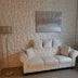 Niton PVC Wall Panels used in a chic living room behind a white tufted sofa, adding depth and elegance to DIY home renovations.