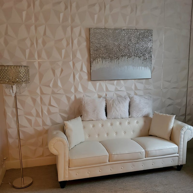 Niton PVC Wall Panels used in a chic living room behind a white tufted sofa, adding depth and elegance to DIY home renovations.