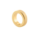 "A gold brass cylindrical knob with a knurled texture, isolated on a white background."