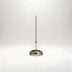 Minimalist pendant light with smoky gray glass dome, copper accent, and black cord against white background.