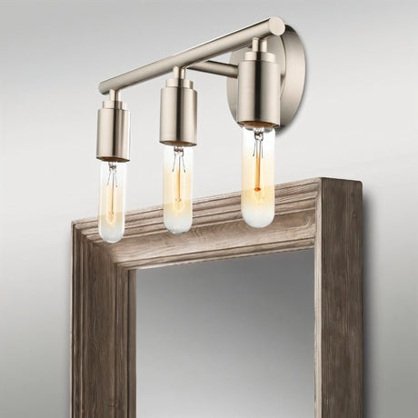 "Brushed nickel 3-light industrial wall sconce with a minimalist design above a mirror."