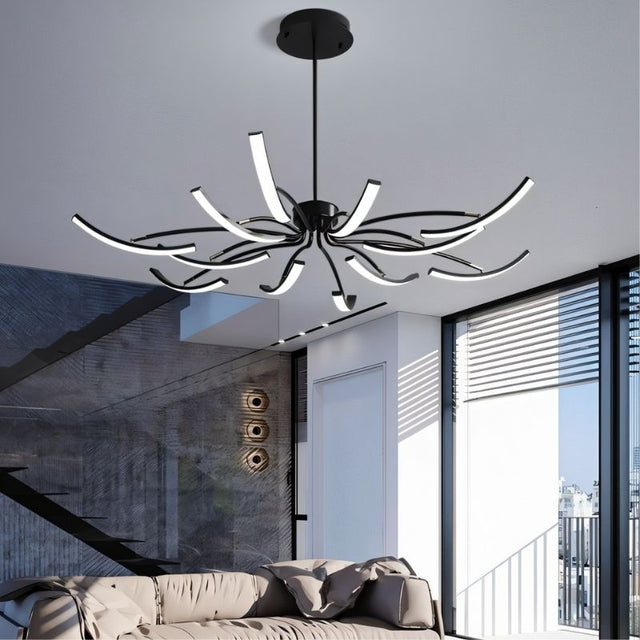 "A black chandelier with twelve curved branches, each tipped with a white light, installed in a modern living room."