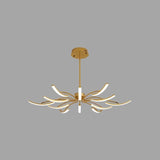 "A gold chandelier with twelve curved branches, each tipped with a white light, and a central white light, against a gray background."