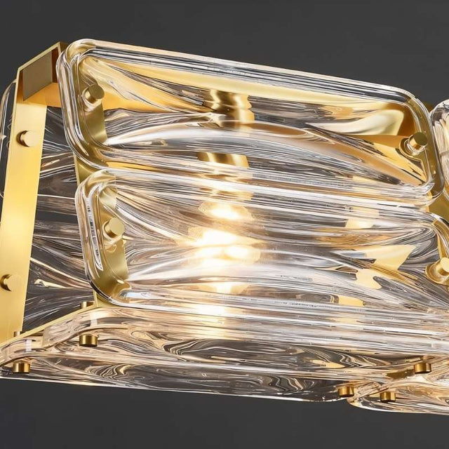 "Close-up of Nyvora ceiling light showing textured glass shades and gold frame detail."