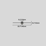 "Dimensions of a modern black wall lamp with a cylindrical bar intersecting a circular base: 15.7 inches in length, 5.1 inches in height and width."