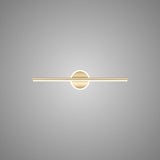 "A modern gold wall lamp with a cylindrical bar intersecting a circular base, showcasing its minimalist design, isolated on a light gray background."