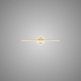 "A modern gold wall lamp with a cylindrical bar intersecting a circular base, showcasing its minimalist design, isolated on a light gray background."