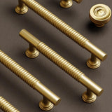 "Set of solid brass knobs and pull bars with a sleek, grooved design, suitable for cabinets, wardrobes, or vanities."