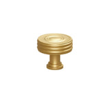 "Solid brass round knob with a grooved design, suitable for cabinets, wardrobes, or vanities."
