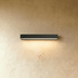 White rectangular wall-mounted LED light fixture above wood-paneled wall in modern interior setting.