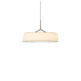 "A pendant light with a wide, white fabric drum shade and a sleek, light-colored frame hangs suspended."
