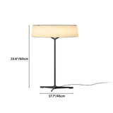"A modern table lamp with a fabric drum shade and a sleek, dark-colored stand with a Y-shaped base."