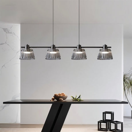 "Modern linear chandelier with ribbed glass shades and a black iron frame illuminating a contemporary dining room."