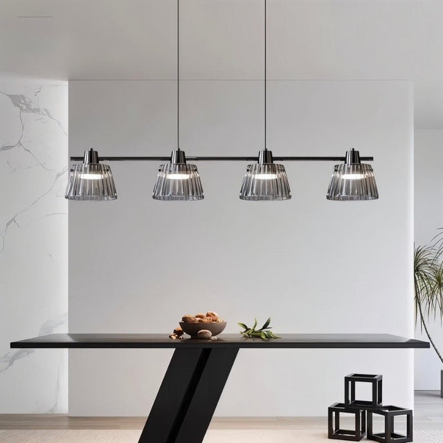 "Modern linear chandelier with ribbed glass shades and a black iron frame illuminating a contemporary dining room."