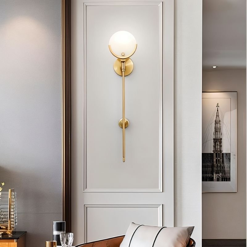 "luxurious brass wall lamp with alabaster globe, stylish lighting fixture for elegant interiors"