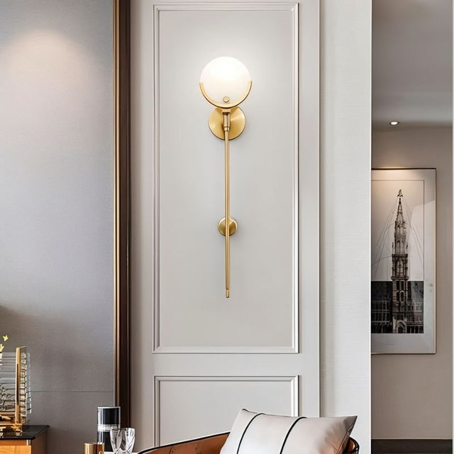 "luxurious brass wall lamp with alabaster globe, stylish lighting fixture for elegant interiors"